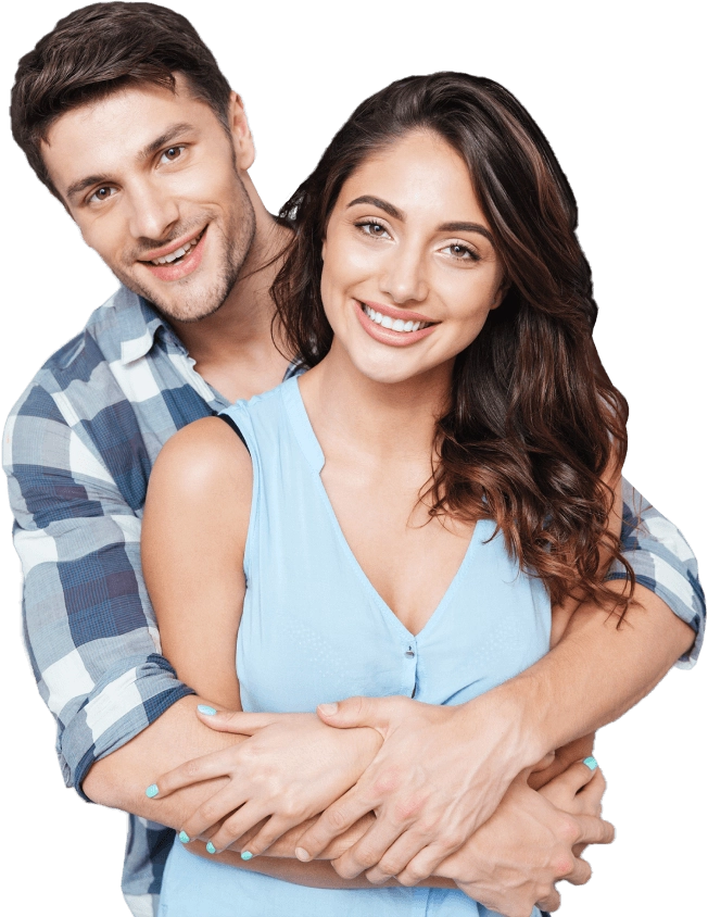 Young couple smiling at camera, man hugging woman from behind in casual embrace.